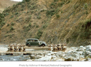 Porters carrying a car across a stream in 1948. Young men in the villages of Makwanpur were hired to transport the vintage German-made Mercedes - Old Photos Of Nepal